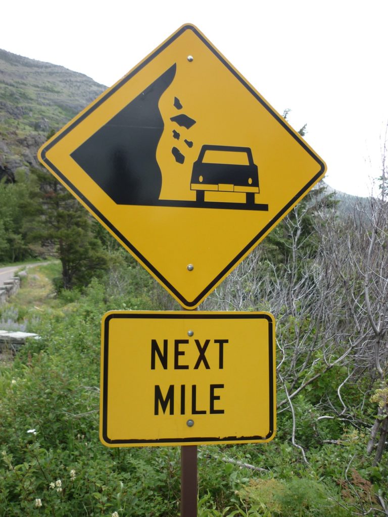 Rocks Falling Road Sign Next Mile