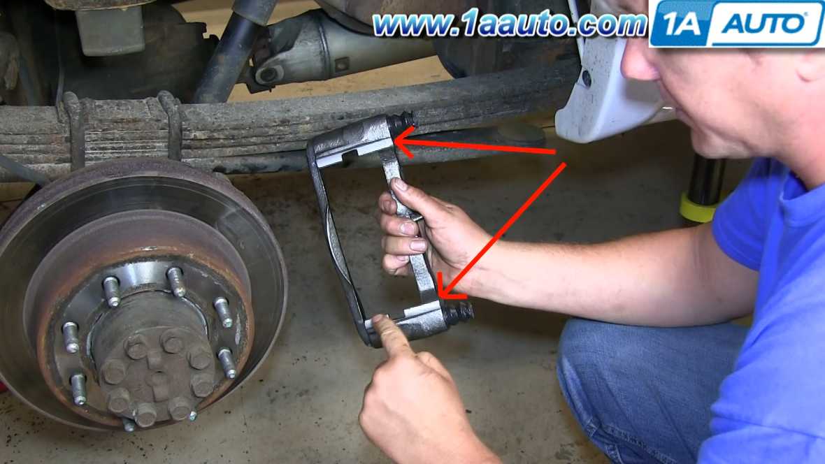 Replace the old caliper bracket with a new one and reassemble parts of the caliper