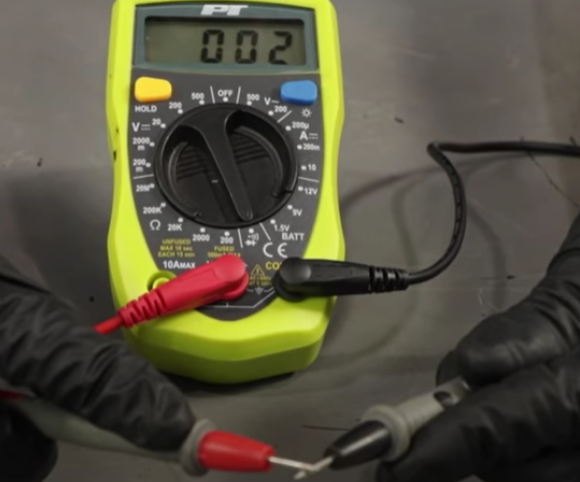 Placing the tips of a multimeter's probes together to test the meter