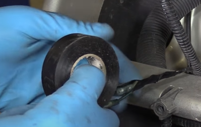 Applying electrical tape to an electrical wire