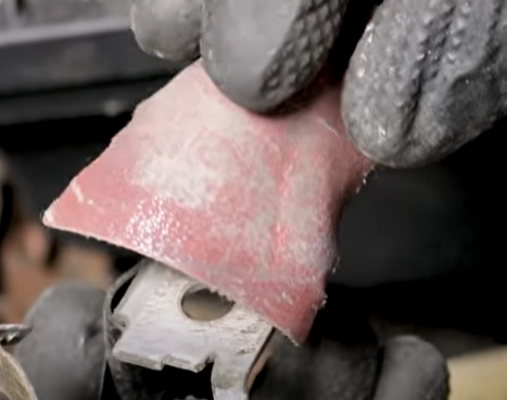 Cleaning a battery cable from corrosion with sand paper