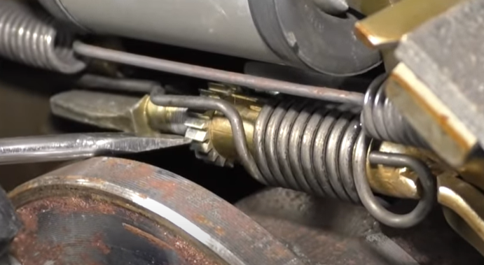 Turning an adjuster wheel up with a flat blade screwdriver
