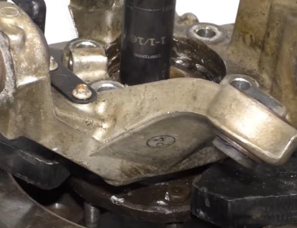 Removing a stuck wheel bearing from a wheel hub assembly with a press