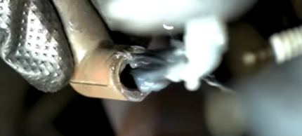 Applying dielectric grease to a spark plug wire