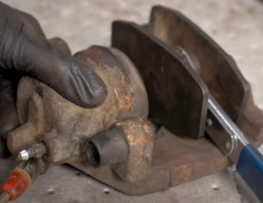 Removing a seized brake caliper piston with air pressure