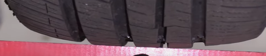Ruler showing how the front tires have curved and rounded at the edges