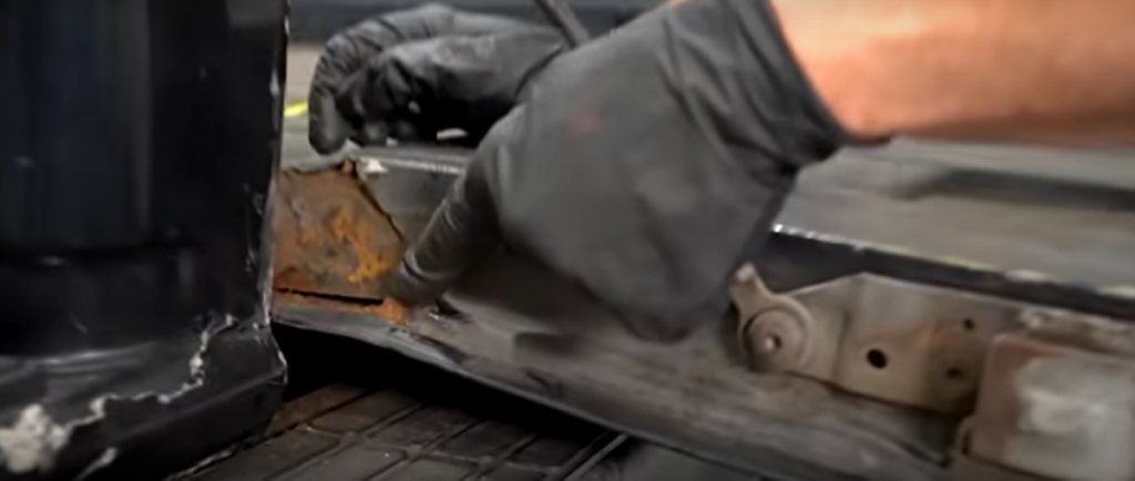 Broken rusted tailgate with cracks that won't close