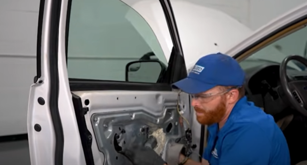Mechanic inspecting rattling in a car door