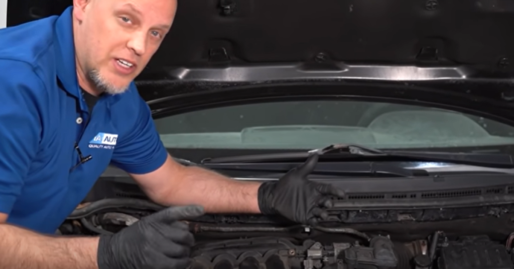 Mechanic reviewing air intake system parts that can cause poor gas mileage