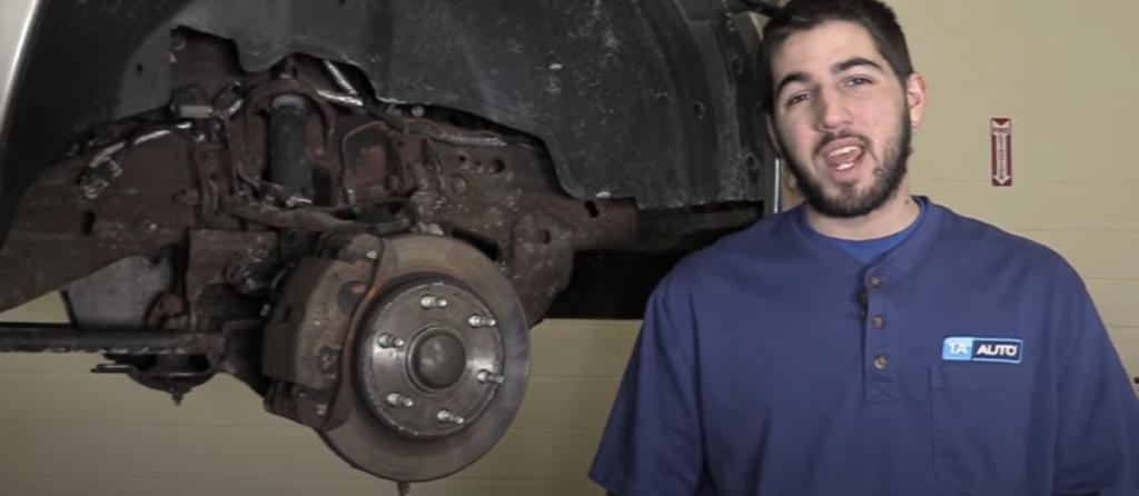1A Auto mechanic reviewing how to bleed the brakes with a 2nd person