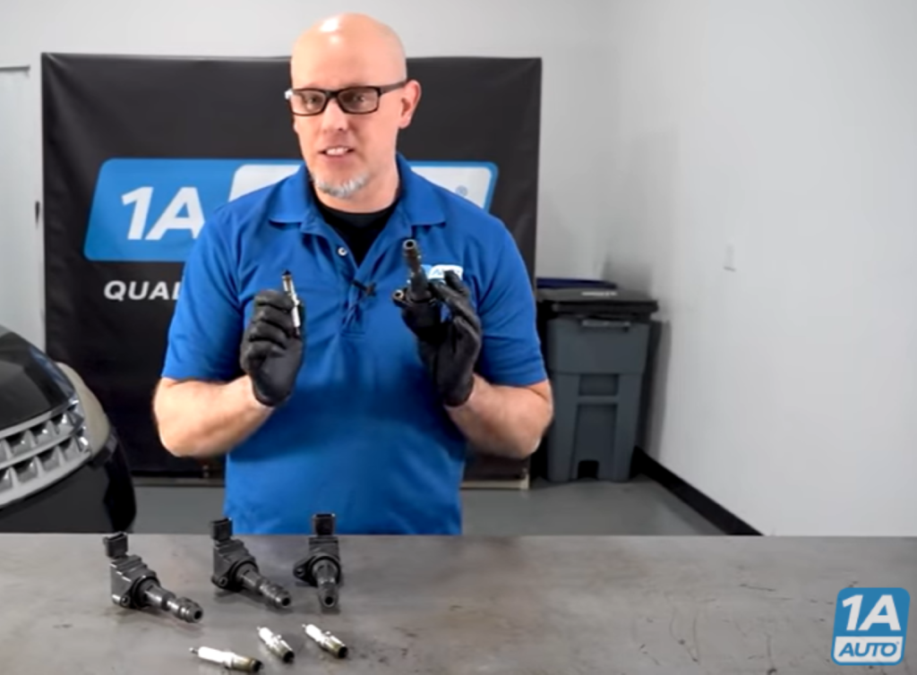 1A Auto mechanic reviewing how faulty and worn spark plugs and ignition coils can cause a misfire, shaking engine, and flashing check engine light in your car
