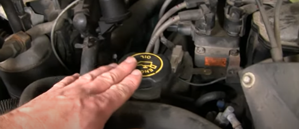 Mechanic reviewing where to add oil in a car, truck, or SUV and how to check the oil level yourself