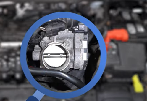 Throttle body with the air intake hose disconnected on a 2011 to 2019 Ford Fiesta