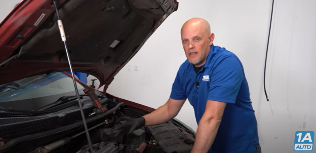 Mechanic under the hood reviewing the top 5 problems with the Pontiac Vibe