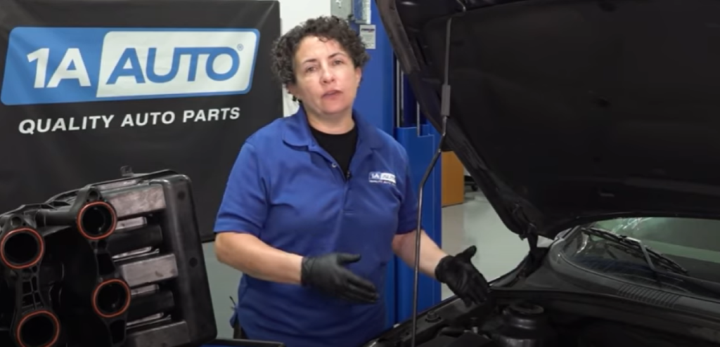 Mechanic under the hood reviewing what parts can cause a vacuum leak in your car