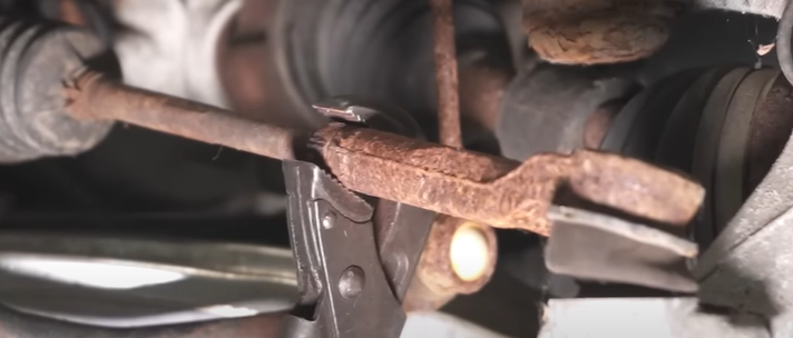 Wrench loosening an inner and outer tie rod nut