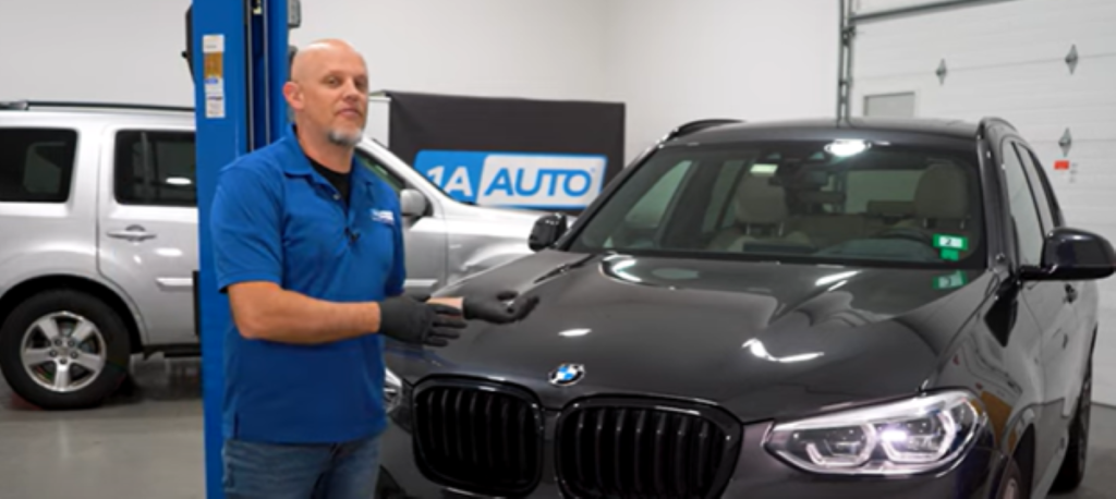 Mechanic standing before a 3rd generation 2017 to present BMW X3