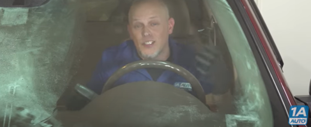 Mechanic in a car with a windshield that keeps fogging